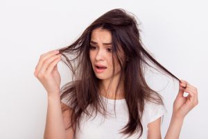 Frustrated woman with split ends