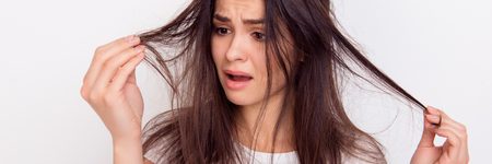 Frustrated woman with split ends