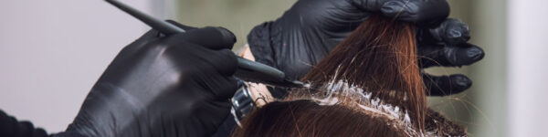 woman getting her hair colored by hair stylist